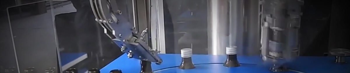 ROPP bottles moving through a rotary capping machine